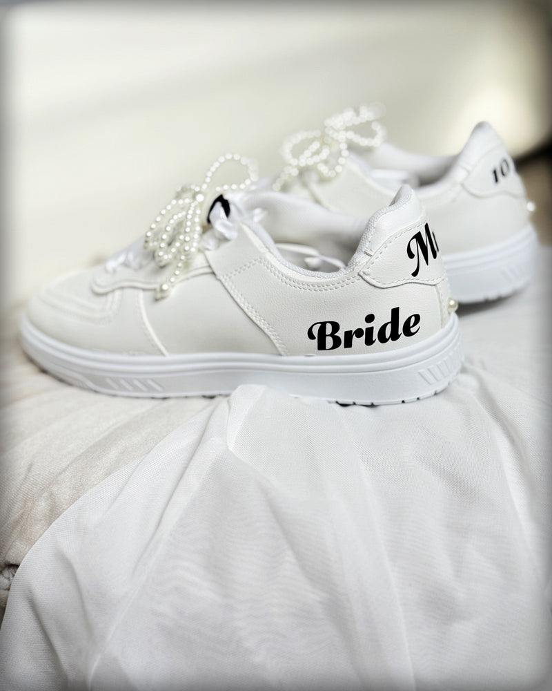 White Comfy-Stylish Personalized Bride Sneakers, customized with Pearl Bow Shoe Charms Clips with Satin Lux Laces and Permanent Vinyl